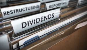 File tab with focus on the word dividends. Conceptual image for illustration of company restructuring plan and dividend.