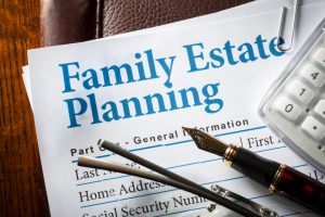 Estate Planning with pen, glasses, and caculator